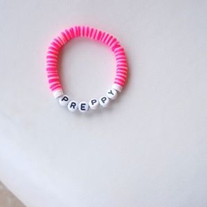 Clay bead bracelet that says preppy light pink and dark pink.